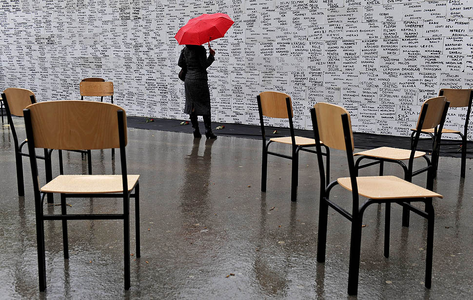 A Kosovo Albanian women stands in front of a wall depicting the names of missing people since the 1998-99 conflict in Kosovo, during the Day of Missing Persons in Pristina on April 27, 2011. About 2,000 people, mostly Albanians, remain unaccounted since the end of the 1998-99 conflict. AFP PHOTO / ARMEND NIMANI (Photo credit should read ARMEND NIMANI/AFP/Getty Images)
