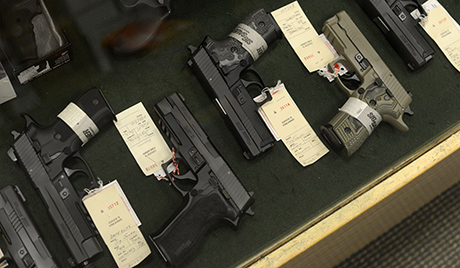 epa03319995 Handguns for sale at Chuck's Firearms gun store in Atlanta, Georgia USA, 27 July 2012. Reaction to the mass shooting at a movie theater in Aurora, Colorado, has included calls for further restrictions on certain weapons and high capacity ammunition clips.  EPA/ERIK S. LESSER