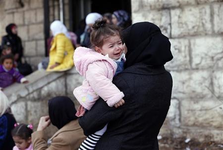 Palestinian women, who had been living at Yarmouk Palestinian refugee camp in Syria, wait outside the Lebanese immigration authority to have their papers stamped at the Lebanese-Syrian border, in al-Masnaa December 18, 2012. REUTERS/Jamal Saidi