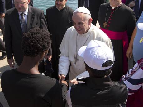 Pope Francis speaks to migrants during his visit to the island of Lampedusa, southern Italy, Monday July 8, 2013. Pope Francis traveled Monday to the tiny Sicilian island of Lampedusa to pray for migrants lost at sea, going to the farthest reaches of Italy to throw a wreath of flowers into the sea and celebrate Mass as yet another boatload of Eritrean migrants came ashore.
ANSA/ALESSANDRA TARANTINO/POOL