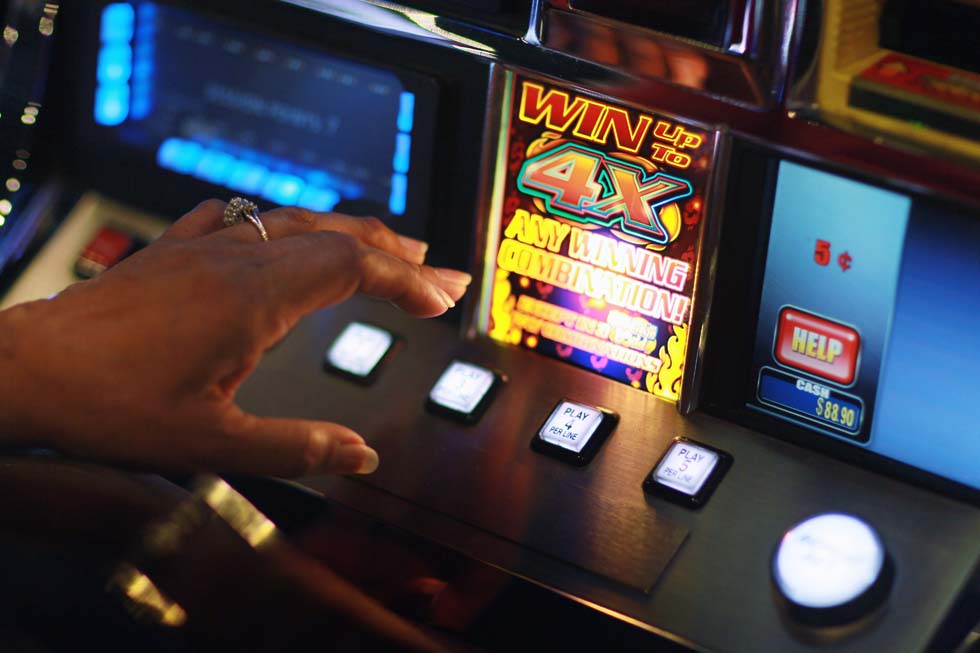 COCONUT CREEK, FL - DECEMBER 17:  Janice Brown plays a slot machine during the grand opening of the newest building at the Seminole Casino Coconut Creek on December 17, 2010 in Coconut Creek, Florida. The site offers up an additional 400-plus gaming positions, a new restaurant and a new venue with more space to gamble, dine and party.  (Photo by Joe Raedle/Getty Images) *** Local Caption *** Janice Brown