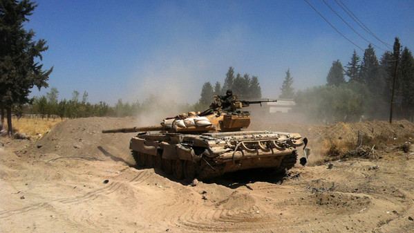 A Syrian army tank maneuvers in the Eastern Ghouta area on the northeastern outskirts of Damascus on August 30, 2013. US President Barack Obama said he had taken no "final decision" on striking Syria but that the world could not accept the gassing of women and children.  AFP PHOTO/SAM SKAINE        (Photo credit should read SAM SKAINE/AFP/Getty Images)