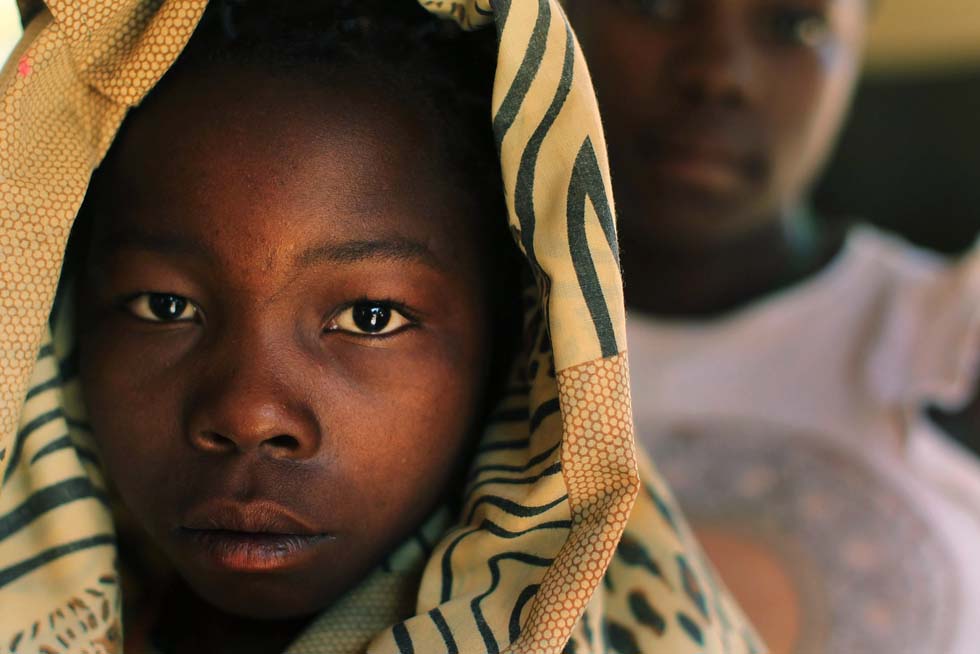 YAMBIO, SUDAN - JANUARY 13: Simba, 14, one of thousands of children who had been kidnapped by the Lords Resistance Army (LRA) and used as slaves, stands at a half-way house for child victims of the LRA that is run in partnership with Doctors Without Borders (Medecins Sans Frontieres) January 13, 2011 in the town of Yambio, south Sudan. Yambio, a poor and isolated town near the borders of Central African Republic and the Congo, has had a history of conflict due to the presence of the shadowy paramilitary group the Lords Resistance Army (LRA) which has terrorized much of the population along the border regions of the three countries. South Sudan, one of the worlds poorest regions, is participating in an independence referendum following a historic 2005 peace treaty that brought to an end decades of civil war between the Arab north and predominantly Christian and animist south. The south is expected to vote around 99 percent to secede from the north which will also give it a majority of Sudans oil. The result is expected to split Africas largest country in two. Over two million people were killed in the north-south civil war which began in the 1950`s.  (Photo by Spencer Platt/Getty Images)