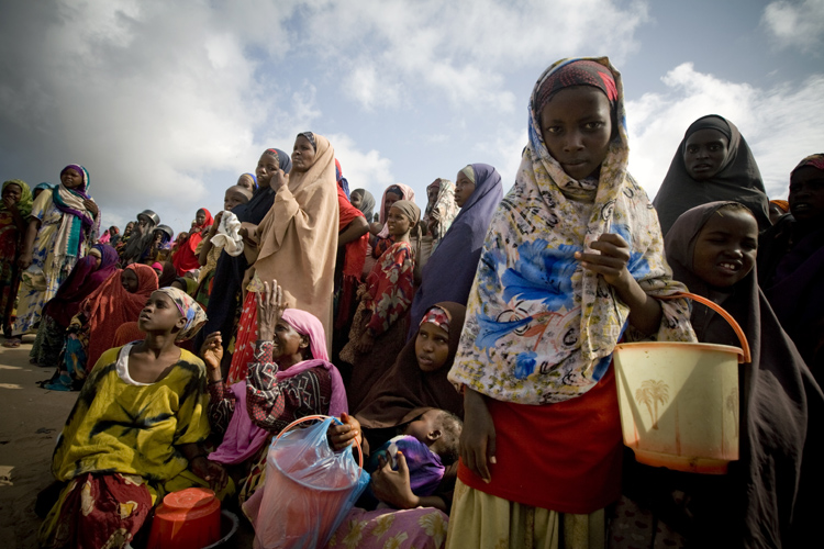 On 24 July, children and women queue for a food distribution, in the Badbado camp in Mogadishu, the capital. The camp, established three weeks ago, shelters almost 30,000 people who have been displaced from rural areas more affected by the drought.

By 29 July 2011, the crisis in the Horn of Africa  affecting primarily Kenya, Somalia, Ethiopia and Djibouti  continues, with a worsening drought, rising food prices and an ongoing conflict in Somalia. More than 12 million people are threatened by the regions worst drought in 60 years. Some 500,000 severely malnourished children in drought-affected areas are at imminent risk of dying, while a further 1.6 million moderately malnourished children and the wider-affected population are at high risk of disease. Somalia faces one of the worlds most severe food security crises; and as many as 100,000 displaced people have sought security and assistance in Mogadishu, the still-embattled capital, in the last two months, and tens of thousands are fleeing into Kenya and Ethiopia. Famine has been declared in the Lower Shabelle and Bakool areas, and it is believed all of Southern Somalia could fall into a state of famine without immediate intervention. Across Southern Somalia, 1.25 million children are in urgent need of life-saving assistance, and 640,000 are acutely malnourished. UNICEF has delivered supplementary feeding supplies for 65,000 children and therapeutic food for 16,000 severely malnourished children in Southern Somalia, and is working with UN, NGO and community partners to expand blanket supplementary feeding programmes where needed. UNICEF is also supporting a range of other interventions, including an immunization campaign targeting 40,000 children in Mogadishu. A joint United Nations appeal for humanitarian assistance for the region requires US$2.5 billion, less than half of which has been committed.