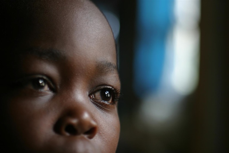 A former child soldier sits inside the dormitory of the UNICEF-supported Centre de Transit et Orientation (CTO), a shelter and reintegration centre for recently demobilized child soldiers, in the eastern town of Goma, capital of North Kivu Province. The CTO provides medical and psychosocial care, as well as family tracing and reunification services. Nationwide, over 33,000 child soldiers remain active.

In March 2005 in the Democratic Republic of Congo (DRC), insecurity and massive population displacements continue to challenge relief efforts in the eastern part of the country. An upsurge in violence in the resource-rich Ituri region, including the killing in February of nine MONUC (United Nations Organization Mission in the DRC) peacekeepers, led to a temporary suspension in humanitarian aid to tens of thousands of displaced civilians. Over two-thirds of the displaced are children and women. As aid resumes, the number of displaced continues to grow: up to 88,000 are registered in camps but many more are assumed to be in need of shelter. Some 6 million people throughout the north-eastern region are affected by the ongoing conflict. Hundreds of thousands are victimized in atrocities committed with impunity. Recruitment of child soldiers by all military factions continues. Rape of girls and women is a widespread weapon of war, terrorizing the population and increasing HIV prevalence. This regional fighting is part of a seven-year conflict in which up to 5 million Congolese have died from starvation, disease and warfare. UNICEF is working with other relief groups to meet the basic needs of displaced children and women, as well as to support child soldier demobilization efforts and other health, water and sanitation, education and protection initiatives in the region.