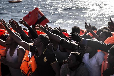 Migrants reach out for floatation vests waiting to board the MV Aquarius, as 193 people and two corpses are recovered Friday Jan. 13, 2017, from international waters in the Mediterranean Sea about 22 miles (35 Km) north of Sabrata, Libya.  The MV Aquarius search and rescue vessel operated by MSF and SOS Mediterranee picked up 183 male and 10 female migrants, thought to have originated from African countries including Nigeria, Gambia and Senegal. The migrants are expected to disembark in Italy. (ANSA/AP Photo/Sima Diab) [CopyrightNotice: Copyright 2017 The Associated Press. All rights reserved.]