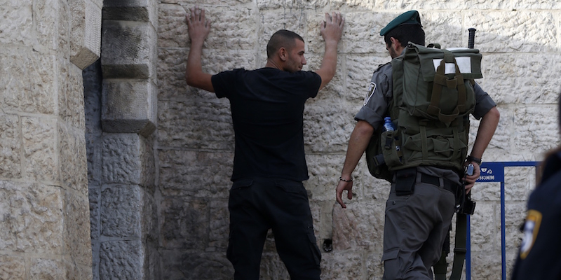 An Israeli policeman checks a Palestinian young man at the Damascus Gate at the entrance of the Old City in east Jerusalem on October 13, 2015 as security measures are increased. Prime Minister Benjamin Netanyahu warned that Israel will use "all means" at its disposal to end Palestinian violence as Jerusalem suffers its bloodiest day in a recent wave of attacks.  AFP PHOTO / AHMAD GHARABLI        (Photo credit should read AHMAD GHARABLI/AFP/Getty Images)