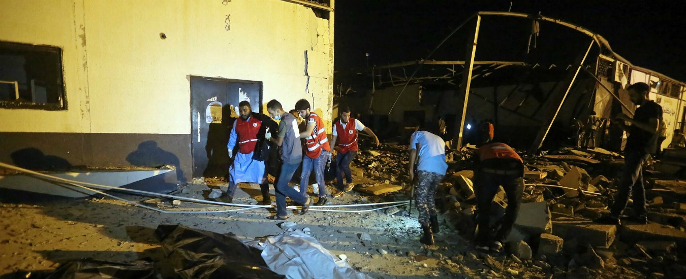 Emergency workers and other recover bodies after an airstrike killed nearly 40 at Tajoura Detention Center, east of Tripoli on early July 3, 2019. - Nearly 40 migrants were killed and more than 70 wounded in an air strike on their detention centre in a suburb of the Libyan capital Tripoli, an emergency services spokesman told AFP. "This is a preliminary assessment and the toll could rise," said spokesman Osama Ali. He said 120 migrants were detained in the hangar, which was directly hit by the strike. (Photo by Mahmud TURKIA / AFP)