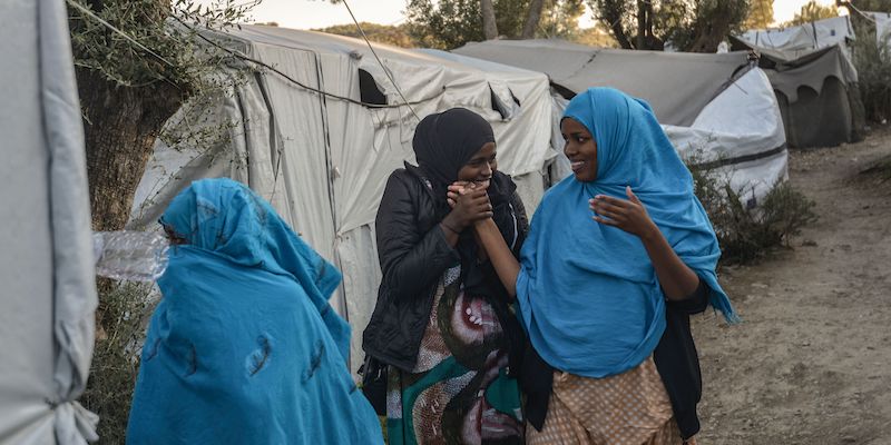 Women stand in a camp outside the refugee camp of Moria, in the northern Greek island of Lesbos on September 25, 2018. - But despite a 2016 agreement between Turkey and the European Union designed at shutting down this particular route into Europe, the migrants are continuing to arrive. About 20,000 refugees and migrants - more than 8,000 of them for the only camp of Moria, with a capacity of 3,000 places - have been confined in Lesbos for months. Most fo them are qualified for passage to Greece. (Photo by Aris MESSINIS / AFP)        (Photo credit should read ARIS MESSINIS/AFP/Getty Images)