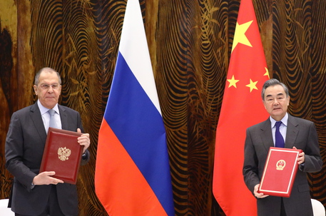 epa09090902 A handout photo made available by the press service of the Russian Foreign Affairs Ministry shows Russian Foreign Minister Sergei Lavrov (L) and Chinese Foreign Minister Wang Yi (R)  posing during a signing cerenony following their talks in Guilin, China, 23 March 2021. Russian Foreign Minister is on a working visit to China  EPA/RUSSIAN FOREIGN AFFAIRS MINISTRY / HANDOUT MANDATORY CREDIT HANDOUT EDITORIAL USE ONLY/NO SALES HANDOUT EDITORIAL USE ONLY/NO SALES