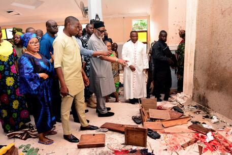 EDITORS NOTE: Graphic content / Ondo State governor Rotimi Akeredolu (3rd L) points to blood the stained floor after an attack by gunmen at St. Francis Catholic Church in Owo town, southwest Nigeria on June 5, 2022. - Gunmen with explosives stormed a Catholic church and opened fire in southwest Nigeria on June 5, killing "many" worshippers and wounding others, the government and police said. The violence at St. Francis Catholic Church in Owo town in Ondo State erupted during the morning service in a rare attack in the southwest of Nigeria, where jihadists and criminal gangs operate in other regions. (Photo by AFP)