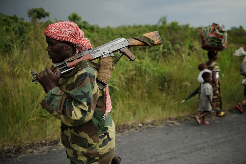 An M23 rebel marches towards the town of Sake, 26km west of Goma, as thousands of residents flee fresh fighting in the eastern Democratic Republic of the Congo town on November 22, 2012. Fighting broke out this afternoon causing people to flee the town and head east, towards Goma, to the camps for the internally displaced in the village of Mugunga. (Phil Moore/Getty Images)