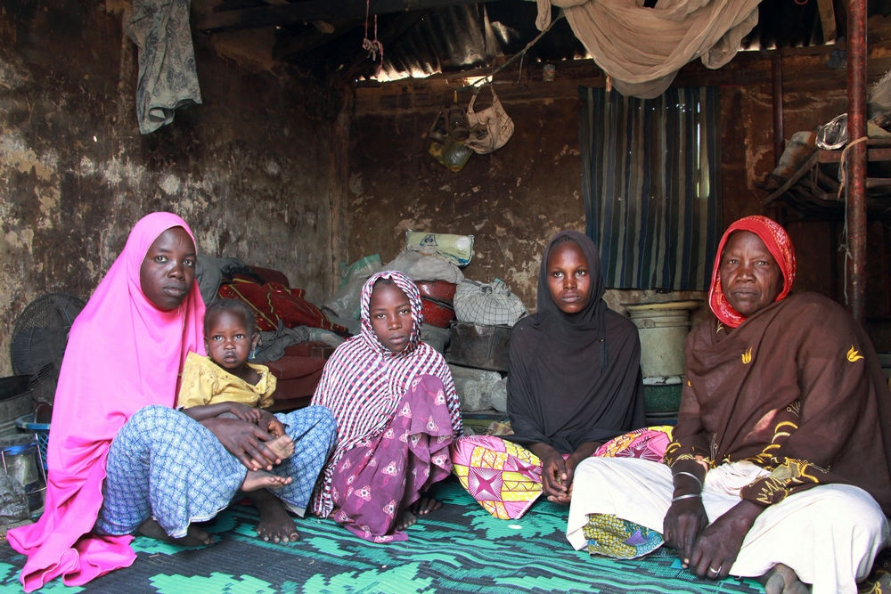 L-R  Kaltuma, 25, her daughter Aisha, 3, her sister Fatima, 10, her sister Aisha, 20, with her son Baba Ali, ten months old and mother of the family Hauwa Abba, 55. The Abba family fled their home in Abadan, near the border with Niger, two years ago following an attack. They have been living in a camp on the outskirts of Maiduguri since then. They were one of 500 families to receive food from MSF on December 14, 2016.